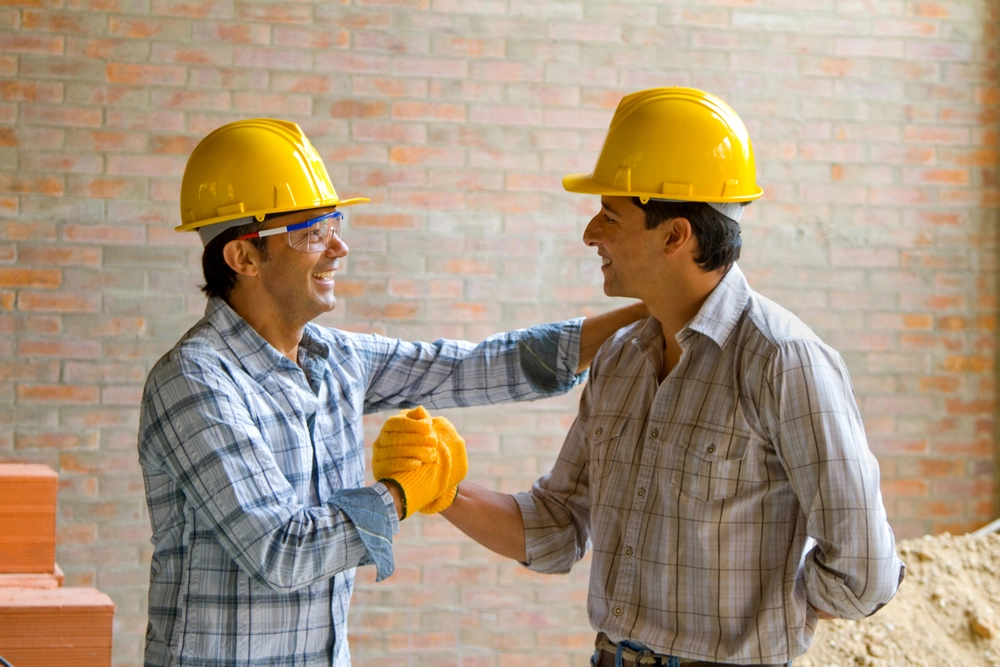 Happy Construction Workers Wearing Helmets